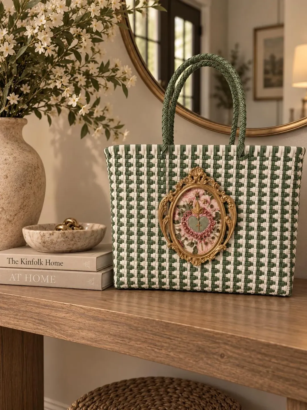 Green woven handbag with a decorative heart, displayed on a wooden table